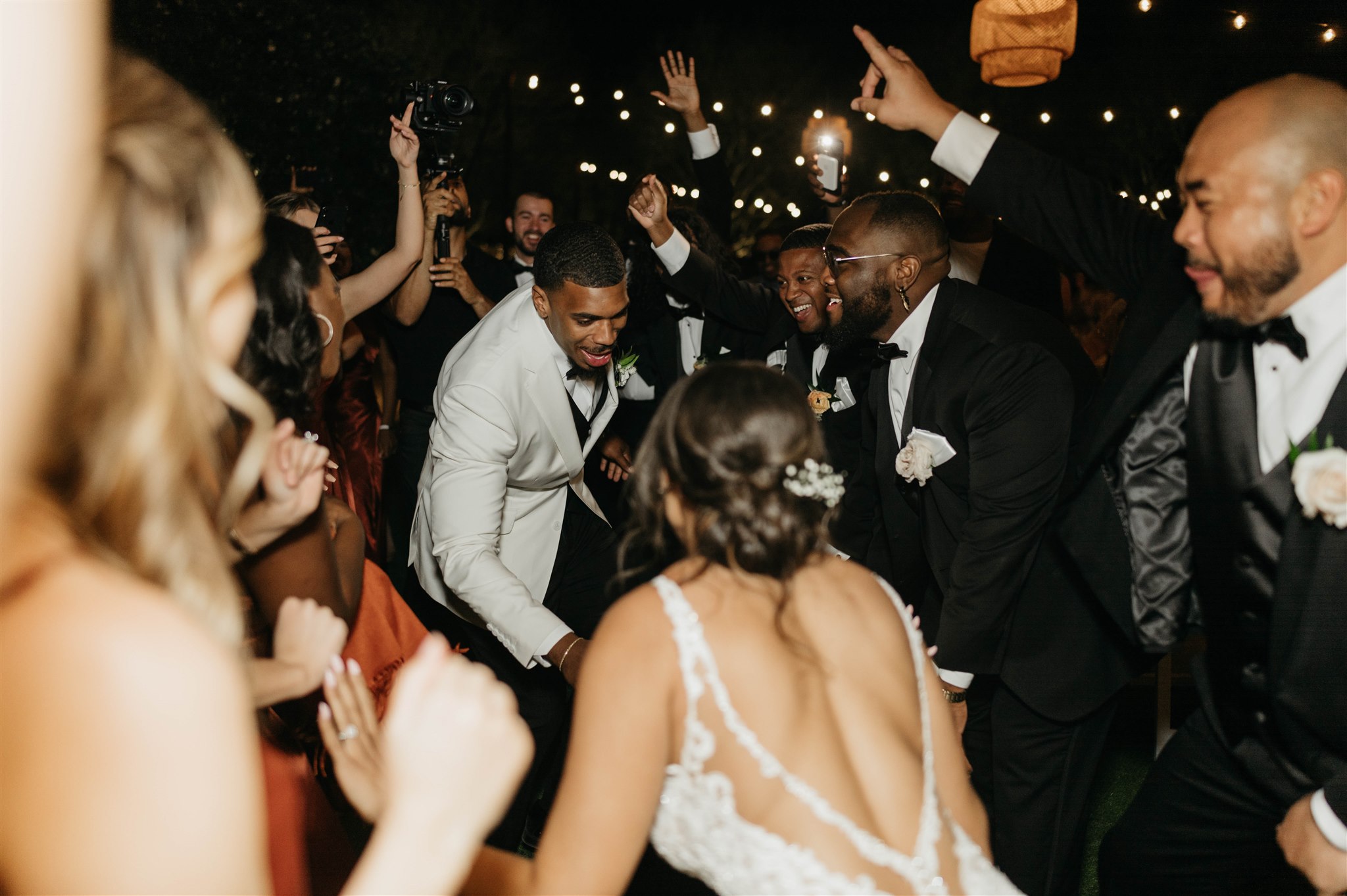 Groom dancing with bride to sparklers